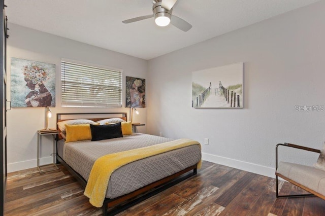 bedroom with dark hardwood / wood-style floors and ceiling fan