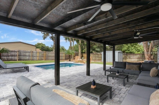 view of patio featuring a shed, an outdoor living space, and ceiling fan