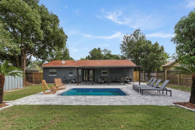 view of swimming pool featuring a lawn and a patio area