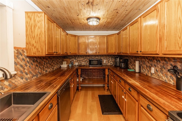 kitchen featuring appliances with stainless steel finishes, butcher block counters, light hardwood / wood-style flooring, and sink