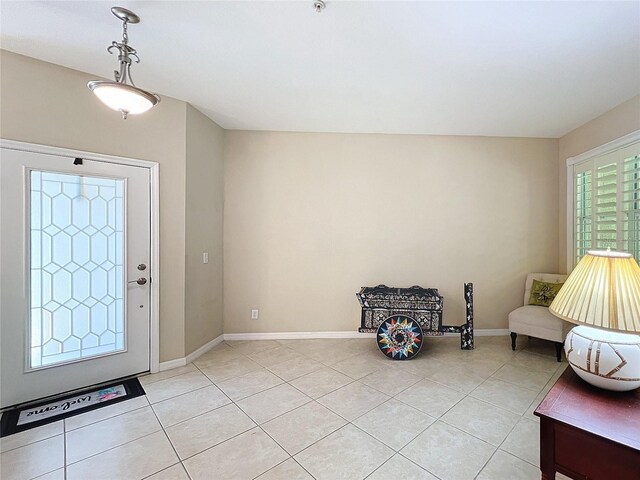 entrance foyer with light tile patterned flooring and vaulted ceiling