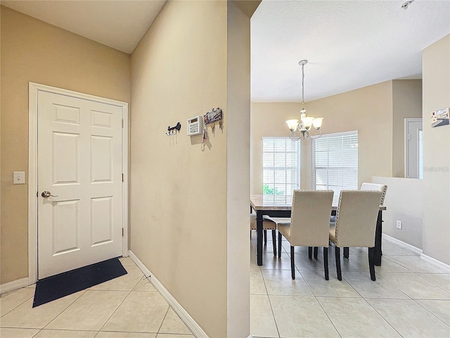 dining area with an inviting chandelier and light tile patterned floors