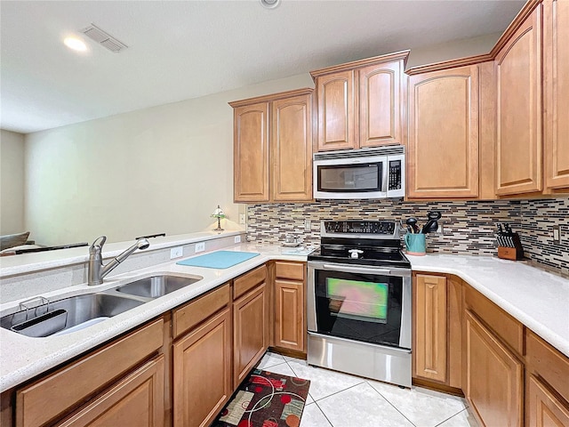 452 Harbor Winds Ct, Winter Springs, FL 32708 - kitchen featuring light countertops, tasteful backsplash, stainless steel appliances, a sink, and light tile patterned flooring