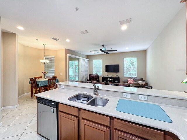 kitchen featuring ceiling fan with notable chandelier, dishwasher, pendant lighting, and a wealth of natural light