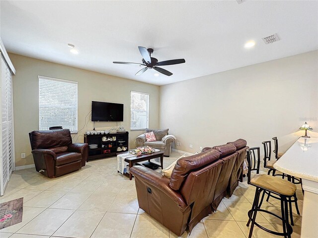 living room featuring ceiling fan and light tile patterned floors