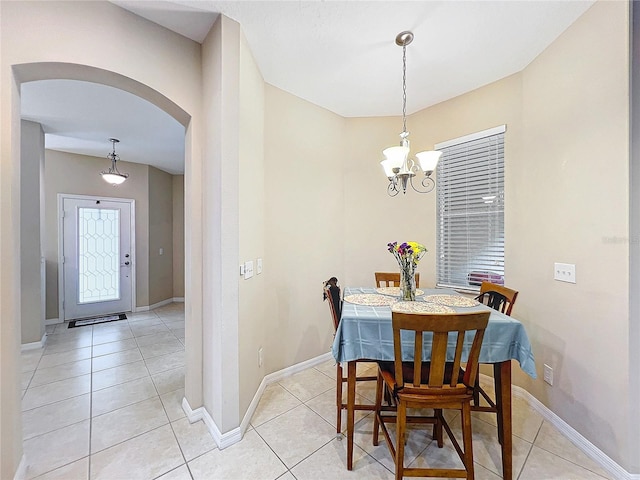 dining room with an inviting chandelier and light tile patterned flooring