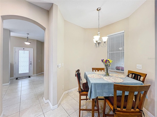 dining room featuring an inviting chandelier and light tile patterned floors