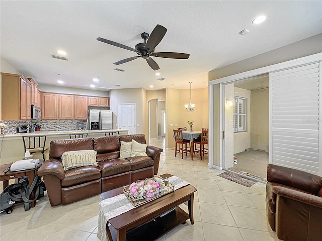 tiled living room with ceiling fan