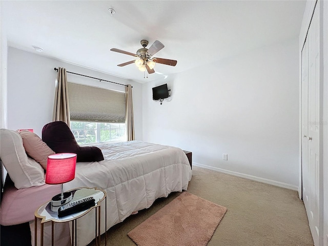 carpeted bedroom with a closet and ceiling fan