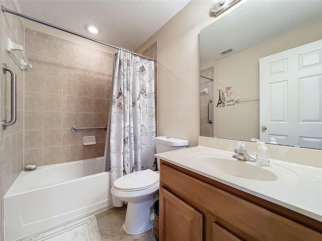 full bathroom featuring vanity, a textured ceiling, tile patterned flooring, shower / tub combo with curtain, and toilet