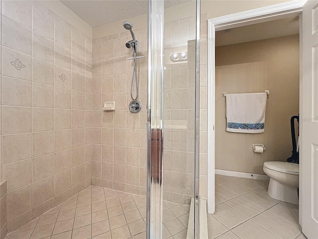 bathroom featuring toilet, tile patterned floors, and an enclosed shower