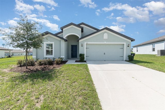 single story home with a garage and a front lawn