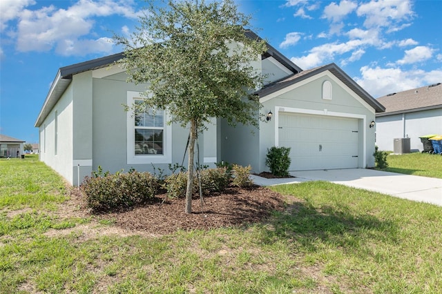 view of front facade with a front yard, a garage, and central air condition unit