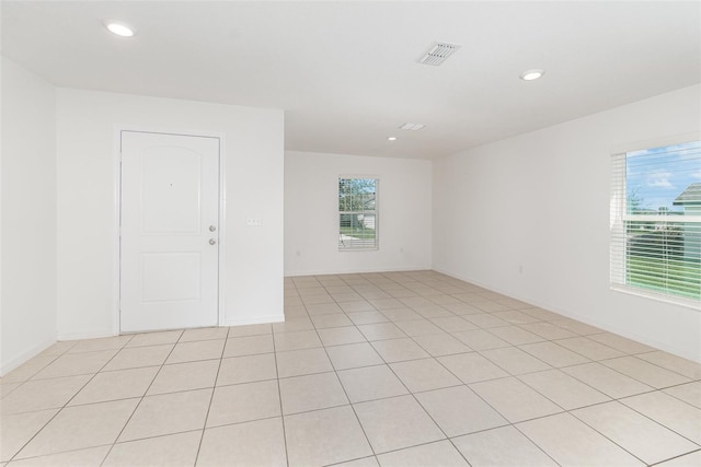 unfurnished room with light tile patterned flooring