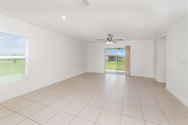 unfurnished room with ceiling fan and light tile patterned floors