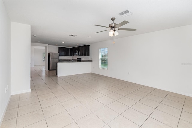 unfurnished living room with ceiling fan and light tile patterned flooring