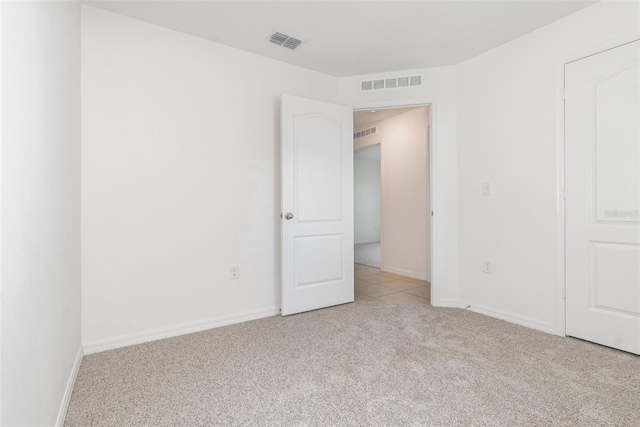 unfurnished bedroom with light colored carpet