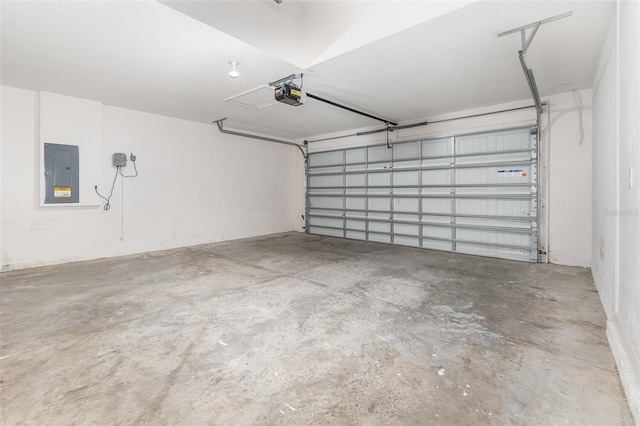 garage with a garage door opener and electric panel