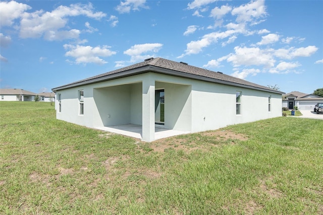 rear view of property featuring a patio and a yard