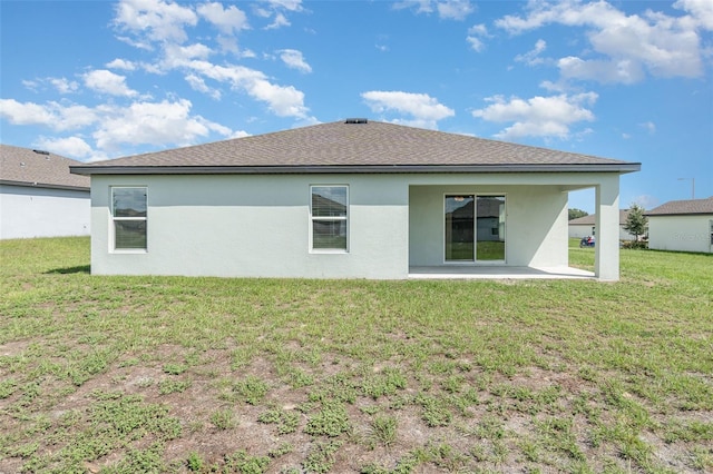 rear view of house with a yard and a patio area