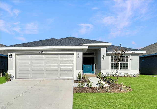 ranch-style home featuring a front lawn and a garage