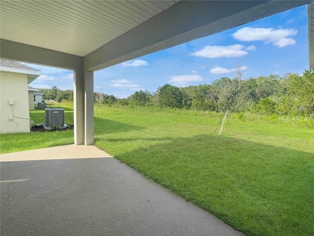 view of yard with a patio and central AC unit