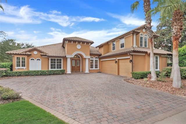 mediterranean / spanish-style house with a garage