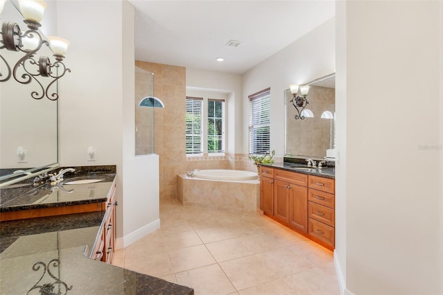 bathroom featuring independent shower and bath, tile patterned flooring, and vanity