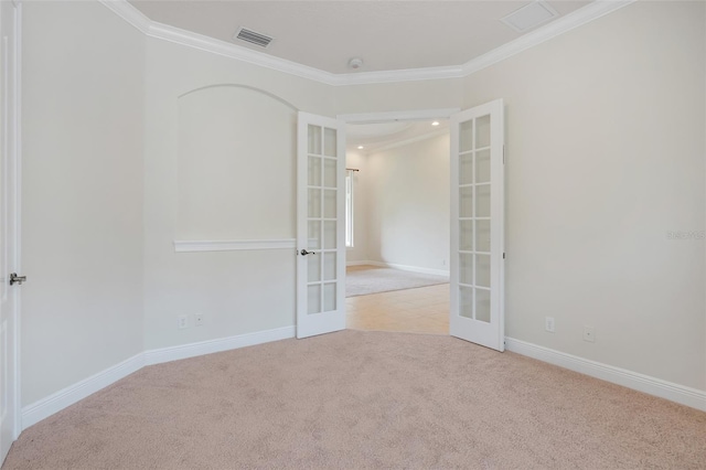 unfurnished room featuring french doors, light carpet, and ornamental molding