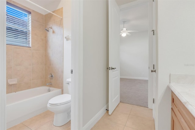 full bathroom featuring ceiling fan, vanity, tiled shower / bath combo, tile patterned flooring, and toilet