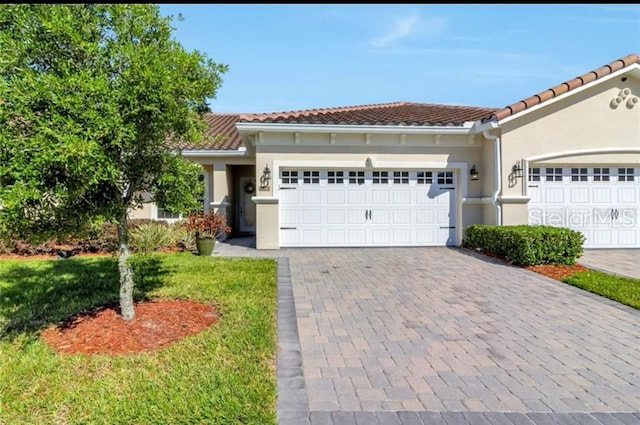 view of front facade with a garage and a front lawn