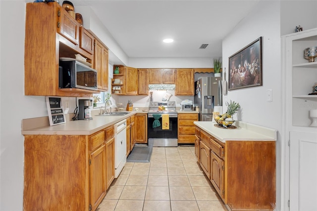 kitchen featuring light tile patterned floors, sink, and appliances with stainless steel finishes