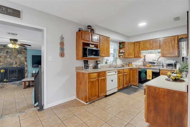 kitchen with visible vents, a sink, stainless steel appliances, light countertops, and extractor fan