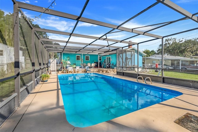 view of swimming pool featuring a patio area and a lanai