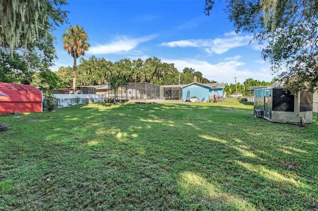 view of yard with a lanai and an outdoor structure