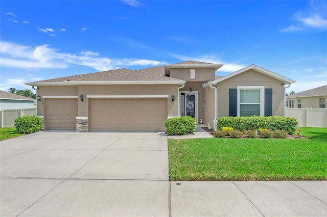 view of front of home featuring a front yard and a garage