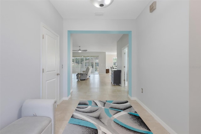 hall featuring light tile patterned flooring