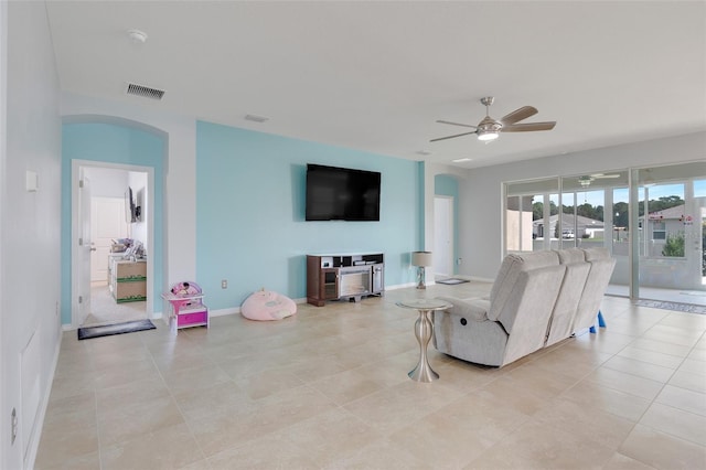 living room featuring light tile patterned flooring and ceiling fan