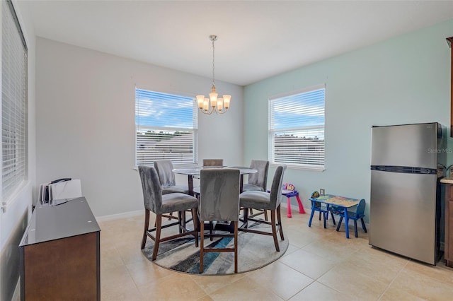 dining space with light tile patterned floors, a chandelier, and a wealth of natural light