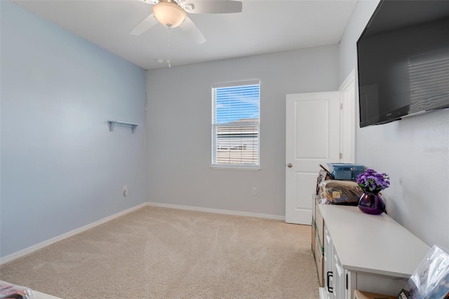 office space featuring ceiling fan and light carpet