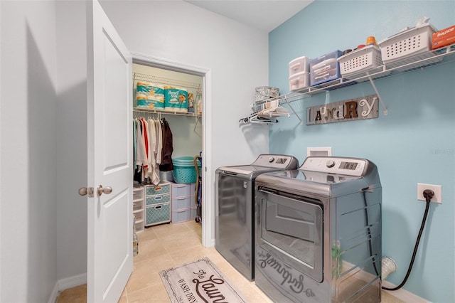 washroom featuring light tile patterned floors and washing machine and dryer