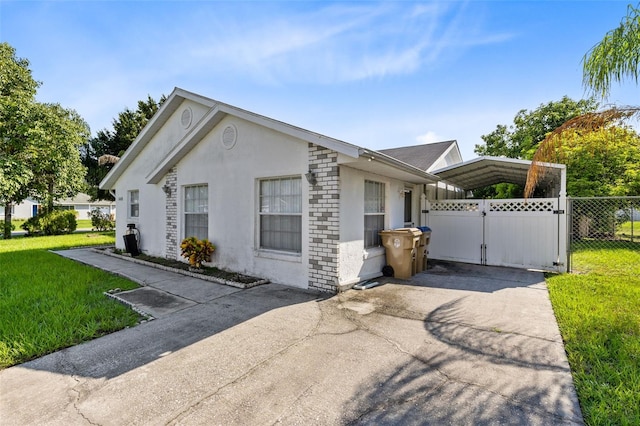 view of side of home featuring a yard and a carport