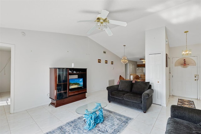 tiled living room with ceiling fan with notable chandelier and vaulted ceiling