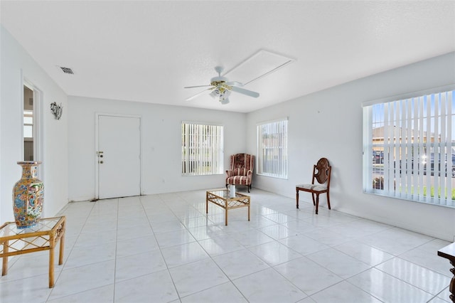 sitting room with light tile patterned floors and ceiling fan