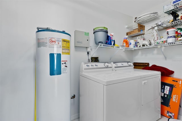 washroom with water heater and separate washer and dryer