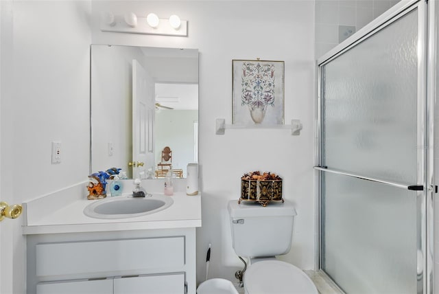 bathroom featuring vanity, toilet, and an enclosed shower