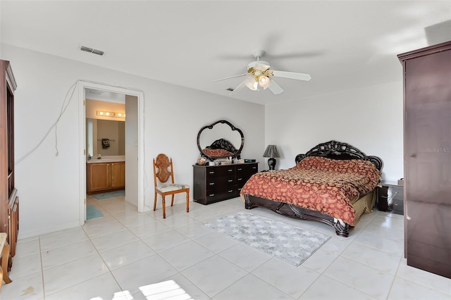 tiled bedroom with ceiling fan and connected bathroom