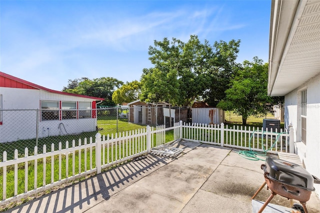 view of patio featuring a storage unit and a grill