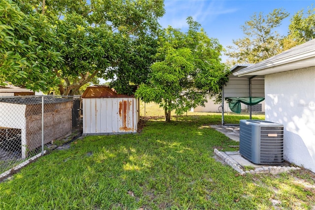 148 Merida Dr, Kissimmee, FL 34743 - view of yard featuring an outbuilding, central air condition unit, a storage unit, and a fenced backyard