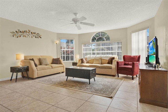 tiled living room featuring a textured ceiling and ceiling fan